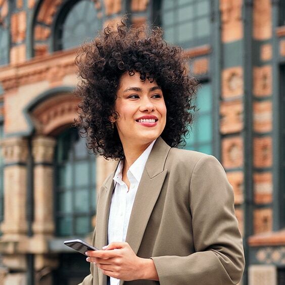 
Business woman smiling with a phone
